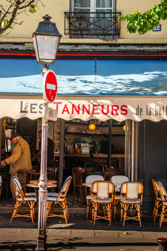 A restaurant with tables and chairs on a street corner