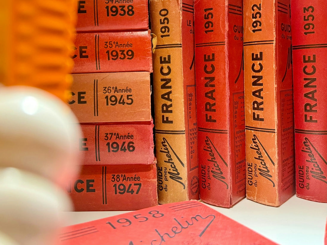 Vintage michelin guides stacked on a shelf